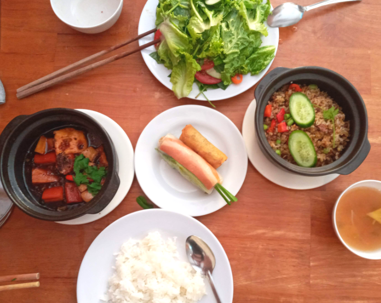 A Vietnamese vegan buffet with spring rolls, a tofu claypot and fried rice